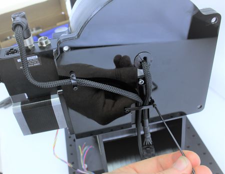 Use the strap to secure the cable and finger tight the M2 screw back..