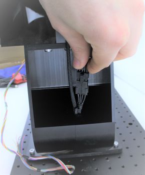 Plug the connector end into the mating connector inside the pocket of the gimbal arm, as shown. The connector should latch securely.