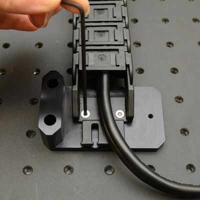 Attach the AP206 to the lower termination of the cable guide (CG01T shown here). Mount the AP206 to the breadboard near the mid-point of X-axis travel, using the provided M6 screws and a 5 mm hex key.