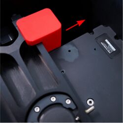 Unscrew the red focus stage retention block and slide it off the focus stage. This block secures the focus stage during shipping and must be removed for operation.