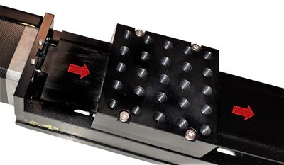 Slide the dust cover and spacer plate out from the end plate and through the carriage. The carriage top can remain in place or be removed.