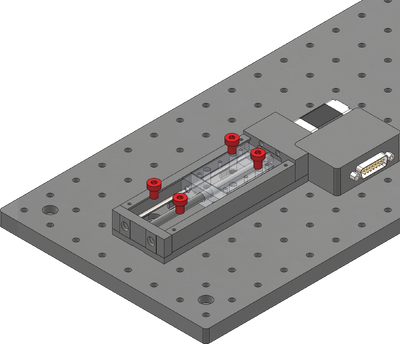 Loosely attach the X-axis stage on a breadboard or other mounting surface using the four provided stainless steel M6 screws and a 5 mm hex key. Move the carriage as necessary to access mounting slots. Where possible, space fasteners out equally and place fasteners at each end of travel.