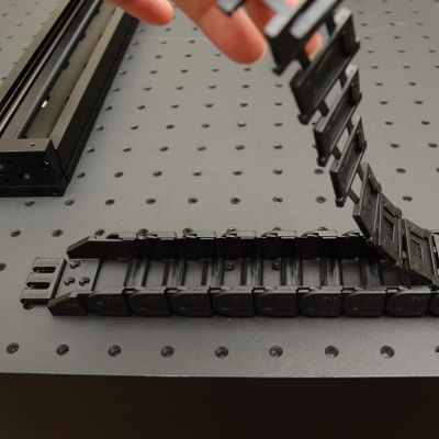 Determine the number of links required for the guide in each axis. See Appendix B: Cable Guide Links for specific quantities. Peel open the cable guide.
