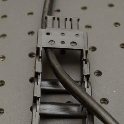 Terminations can be attached in two orientations, depending on how they will attach to the mounting adaptors. If the termination needs to be flipped, you will need to assemble the cable in the guide then remove and re-attach the termination as shown.