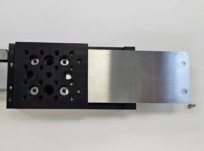 Slide the dust cover out through the carriage. The carriage top can remain in place or be removed.