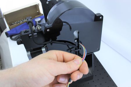 Insert the flying leads of the signal output cable through the back of the hole in the upper axis stage back plate.