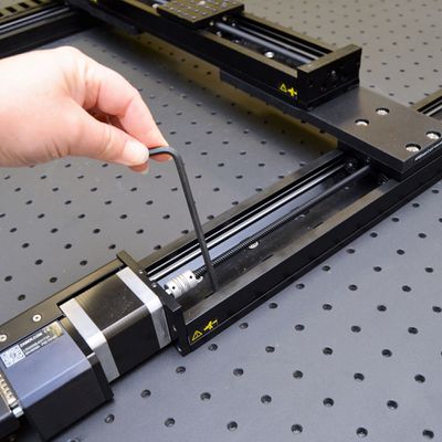 Snug the mounting screws that are now accessible near the home positions for the X-axis travel. Loosen the screws at the far end of the X-axis travel.