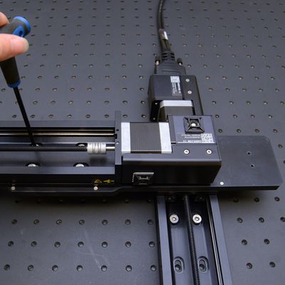 Using four of the M6 low profile screws (provided with the AP200), loosely assemble the Y-axis stage to the AP200 part 1 (the larger plate). Loosely assembly the other end of the Y-axis stage to the AP200 part 2, also using four M6 low profile screws.