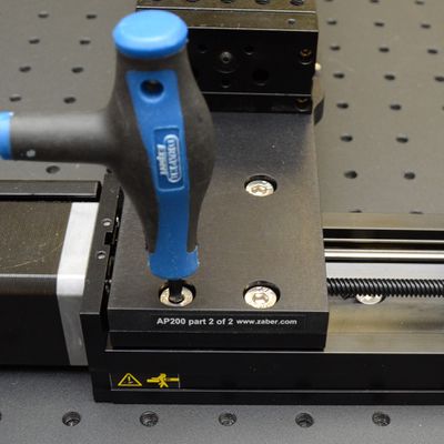 Move the X-axis stages to the home end of travel. Firmly tighten the screws for the AP200 part 2 plate to the X-axis stage.