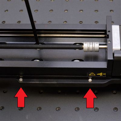 With screws still loose, push the Y-axis stage firmly against the two dowels on the AP200 plate. With both dowels in contact, tighten the M6 screws between the AP200 part 1 (larger plate) and the Y-axis stage. Leave the screws between the other AP200 plate and the Y-axis stage loose for now.