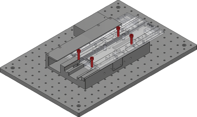 Loosely attach the X-axis stage on a breadboard or other mounting surface using the 4 provided M6x25mm screws and a 5 mm hex key by sliding the stage to one end of travel, exposing the pair of mounting holes. Move the stage to the other end of travel and repeat. Align the stage to your desired point of interest.