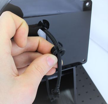 Pull the rubber grommet over the cable with the cutout facing upwards.