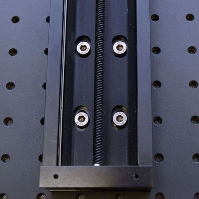 Move the stage along its axis until the mounting screws are approximately centered on the mounting slots. Tighten the eight mounting screws in several steps, alternating diagonally.