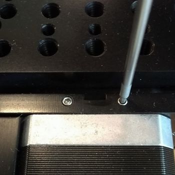 Loosen the two set screws on the motor end plate using a 1.5 mm hex key.
