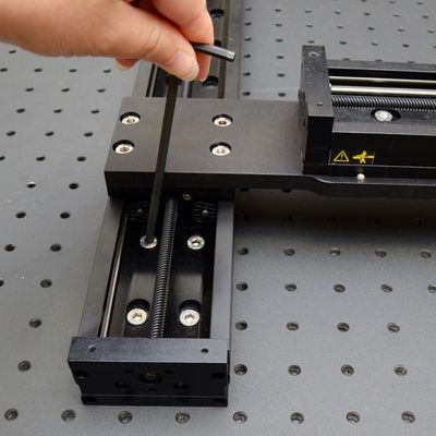 Move the X-axis stages to the far end of travel, then back enough to expose the mounting screws. Firmly tighten the screws at the far end of X-axis travel. Slightly loosen the screws at the home end of X-axis travel.