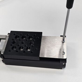 Remove the four M2 screws on each corner of the dust cover using a Phillips screwdriver.