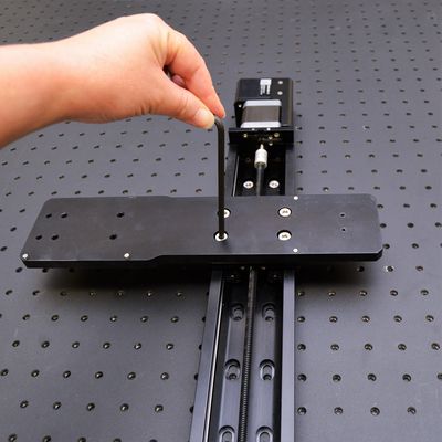 Loosely mount AP200 part 1 on the X-axis 1 stage (connected to X-MCC axis 1) using a 4 mm hex key and four of the provided M6 low profile screws.