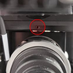 Loosen the camera tube lens and mount lock screw with a 2 mm hex key.