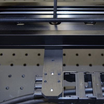 Attach the AP198 part 1 to the bottom of the LSQ X-axis 1 using two M6 screws and the 4 mm hex key. Move the X-axis stages through their full travel to determine a good mounting location (typically around mid-travel) for the AP198 part 1.