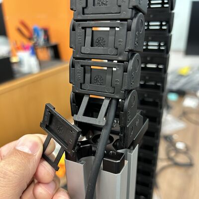 After attaching the cable guide to the end plate remove as many covers from the links as necessary for the cable to freely exit the cable guide.