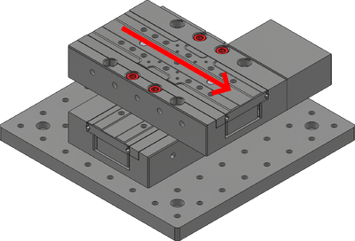 Push the base of the upper-axis stage along the axis of travel, towards its controller, to align it with the dowel pins on the lower-axis stage. Tighten the M6 screws while ensuring the stage alignment does not shift.