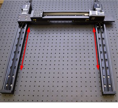 If there is not enough adjustment possible with moving only one X-axis stage, you may wish to loosen and move both X-axis stages along their axes. Note: If you need to move the carriage to access mounting holes for the X-axis stages, use the manual control knob for either axis 1 or 2 on the controller. Both X-axis stages will move together, as they are connected in lockstep. Return the stages to their home position before continuing with the AP200 assembly.